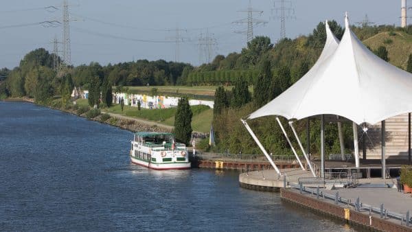Die MS Kettwig auf dem Rhein-Herne-Kanal in Gelsenkirchen. Im Hintergrund die Kanalbuehne und der Nordsternpark.